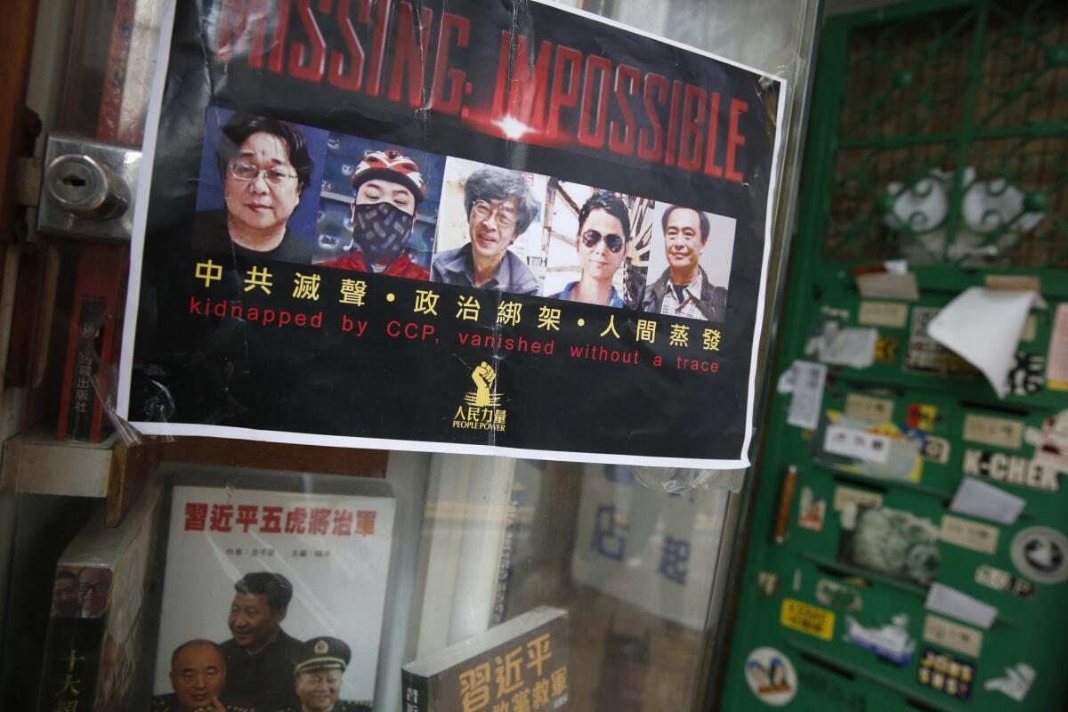 A poster of the five Hong Kong booksellers who were missing until most of them appeared on Chinese television Sunday night.