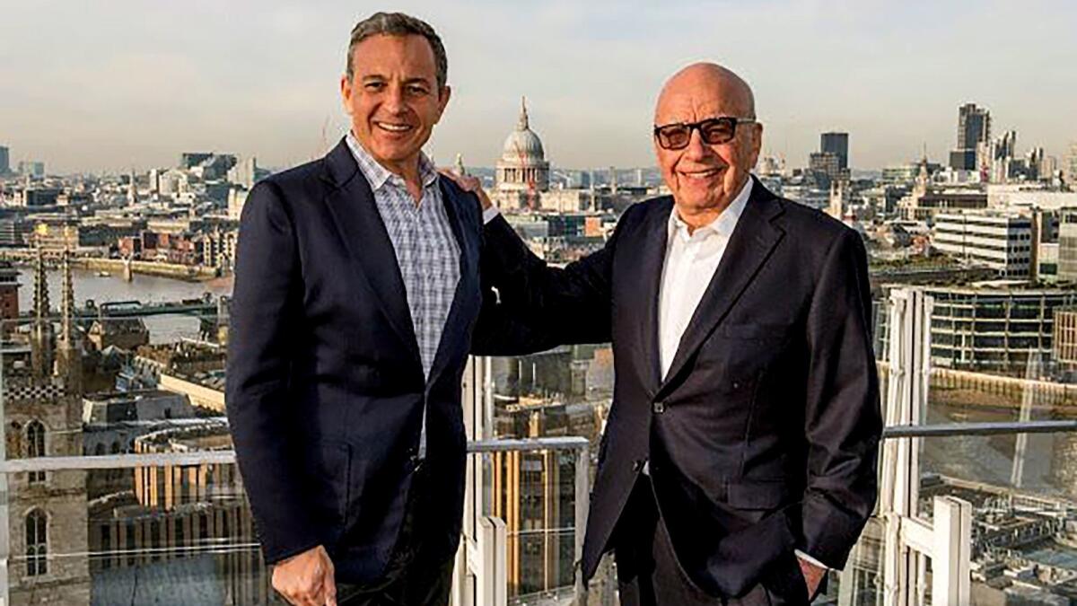 Walt Disney Chief Executive Bob Iger, left, and Fox owner Rupert Murdoch at an undisclosed location. Murdoch and his sons got a big pay bump in fiscal 2018 after orchestrating the sale of much of 21st Century Fox to Walt Disney Co.