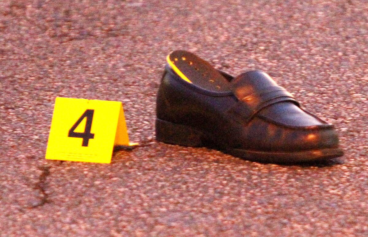 A shoe, tagged as evidence, on the street at the scene where a pedestrian was hit by a motorist on the corner of Glenoaks Blvd. and Western Avenue in Glendale on Monday, January 27, 2014. The pedestrian was taken to the hospital with severe head injuries.