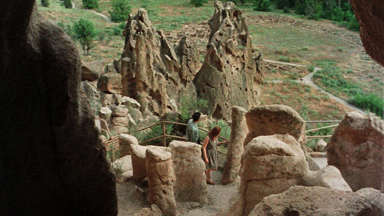 Ancestral Pueblo dwellings built high into walls of soft volcanic rock called tuff line a mile-long trail in the park.