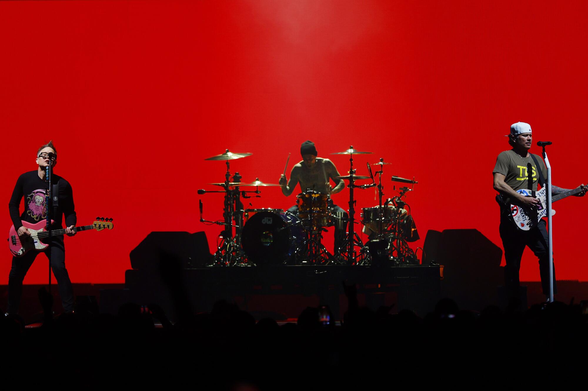 Mark Hoppus, left, drummer Travis Barker and Tom DeLonge of blink-182 