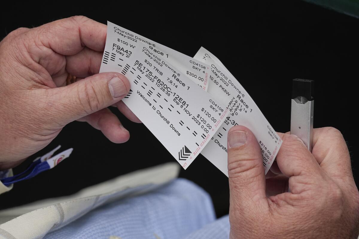 A race fan looks at his wagering tickets