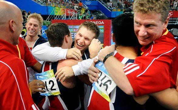 U.S. gymnast Jonathan Horton, center, celebrates with teammates and coaches after the U.S. team won a bronze medal at the Beijing Olympics.