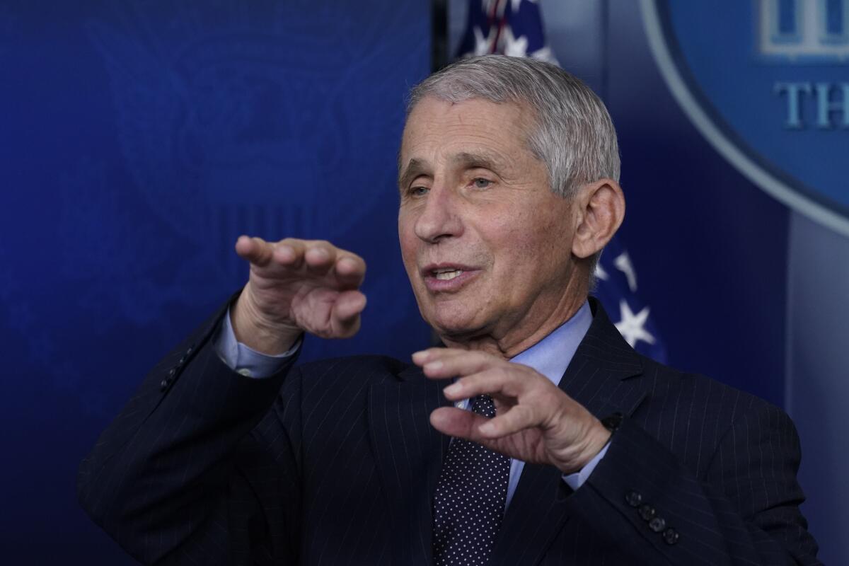Anthony Fauci gestures while speaking onstage.