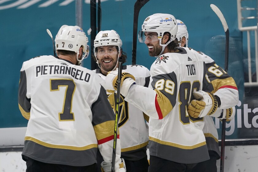 Vegas Golden Knights right wing Alex Tuch (89) celebrates with teammates after scoring a goal against the San Jose Sharks during the second period of an NHL hockey game in San Jose, Calif., Saturday, March 6, 2021. (AP Photo/Jeff Chiu)