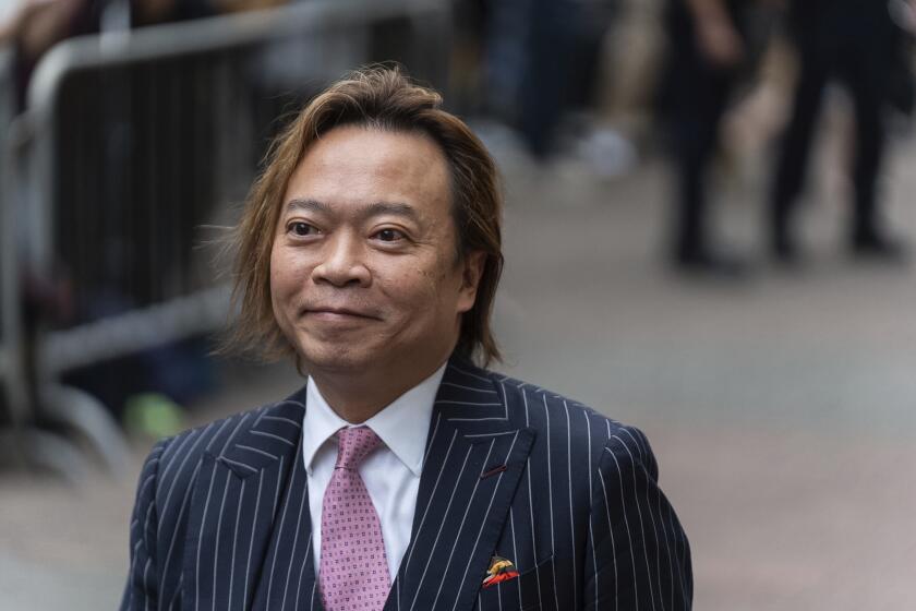 Lawrence Lau, a former pro-democracy district councilor, arrives at the West Kowloon Magistrates' Courts in Hong Kong, Thursday, May 30, 2024. (AP Photo/Chan Long Hei)