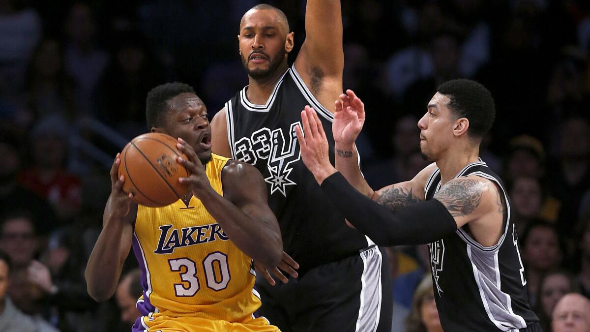 Lakers forward Julius Randle (30) works against the double-team defense of Spurs forward Boris Diaw, center, and guard Danny Green during a game Jan. 22.