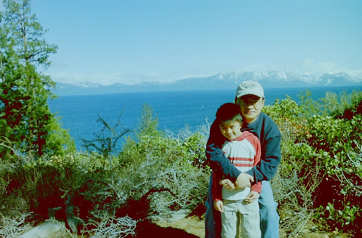 Harry Sentoso poses with his son Evan on a family trip in the early 2000s