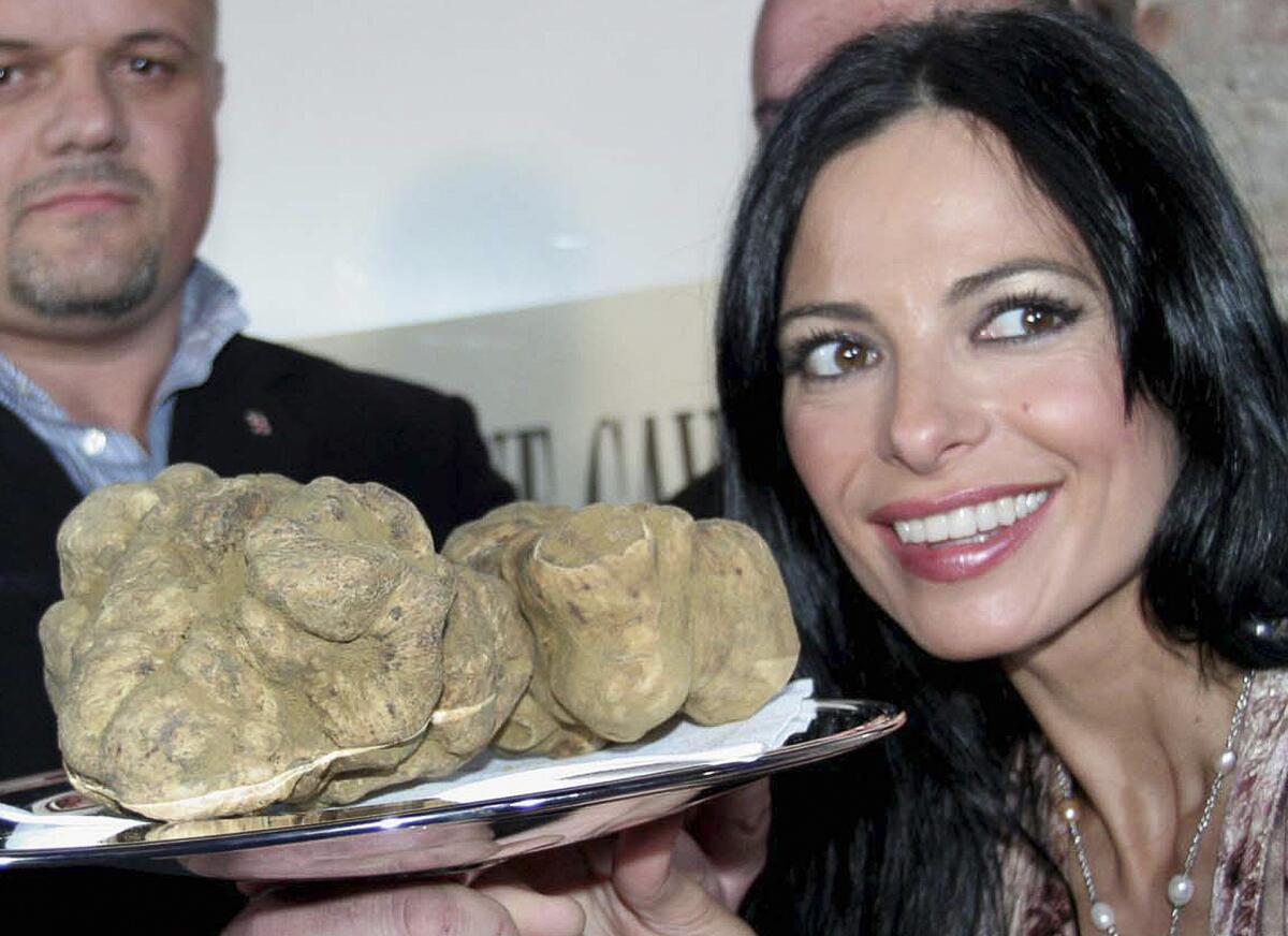 Spanish television personality Natalia Estrada poses with a 2 1/2 pound white truffle.