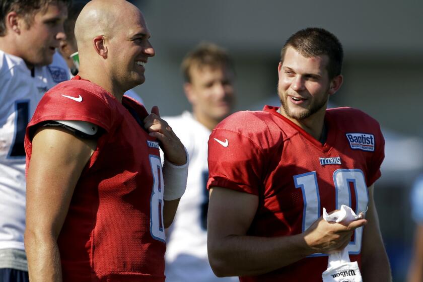 Former Titans quarterback Jake Locker, right, announced Tuesday his decision to retire from the NFL after four years with Tennessee.