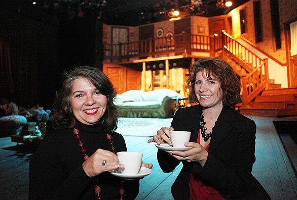 At the classical theater company A Noise Within, the holidays are celebrated with a Victorian tea party. Preparing to hoist a cup at the Dec. 20 event are Julia Rodriguez Elliott, left, who is one of the group's artistic directors, and Samantha Starr, education director. Behind them: the set for the Michael Frayn farce "Noises Off," a performance of which served as post-party entertainment.