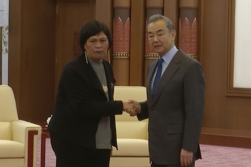 In this image taken from a video footage run by Phoenix TV, New Zealand Foreign Minister Nanaia Mahuta, left, shakes hands with Wang Yi, Chinese Communist Party's most senior foreign policy official during a meeting in Beijing, Friday, March 24, 2023. Mahuta has expressed concern to China over any provision of lethal aid to support Russia in its war against Ukraine during a meeting with her Chinese counterpart. (Phoenix TV via APTN)