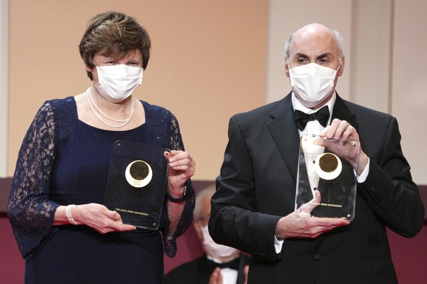 Japan Prize 2022 laureates Katalin Kariko, left, and Drew Weissman pose with their trophies.