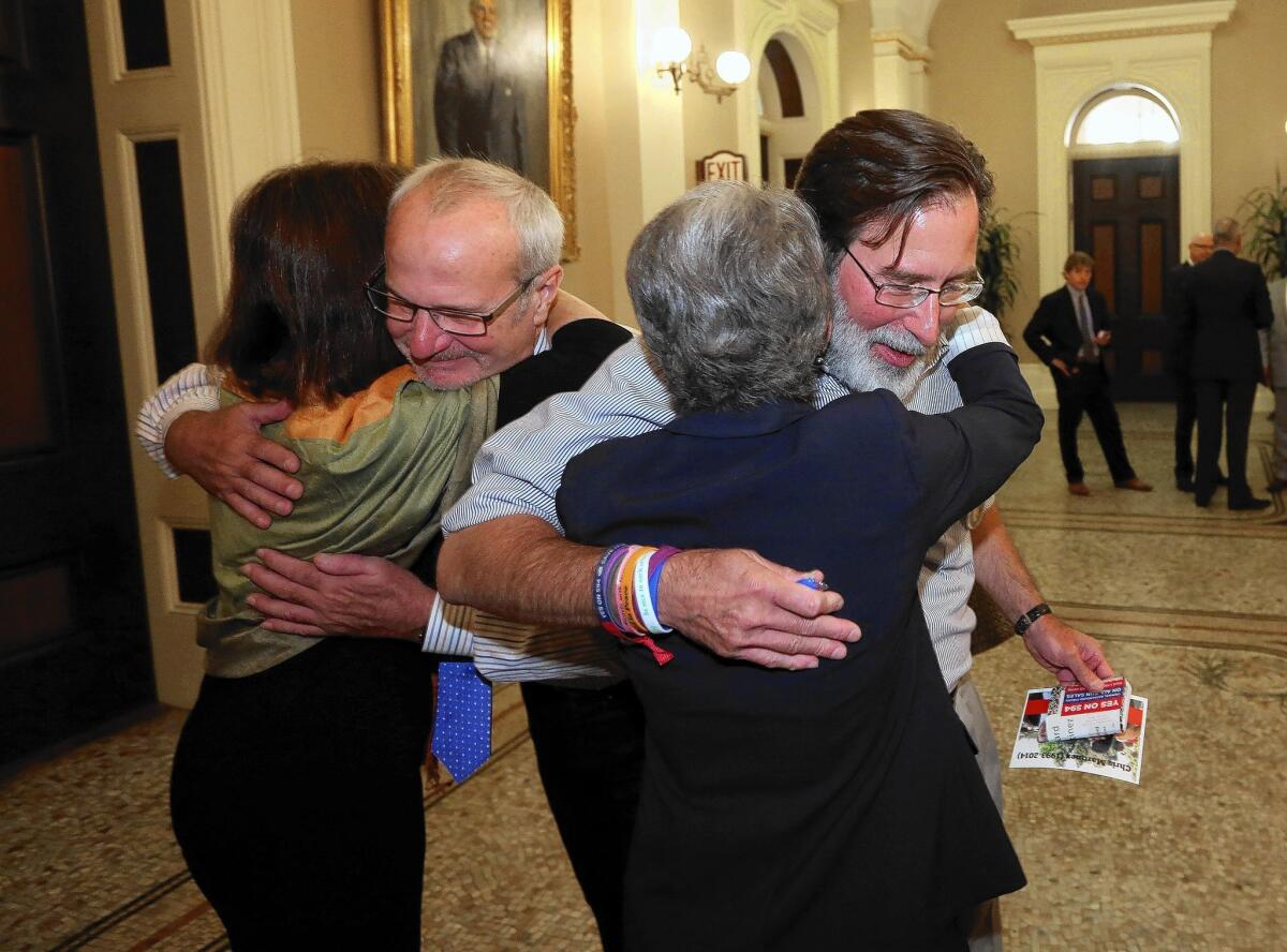 Richard Martinez, right, and Robert Weiss, second from left, who each lost a child in the Isla Vista shooting rampage in May, celebrate the state Senate's approval of a bill tightening gun laws with Assemblywoman Nancy Skinner, left, and Sen. Hannah-Beth Jackson.