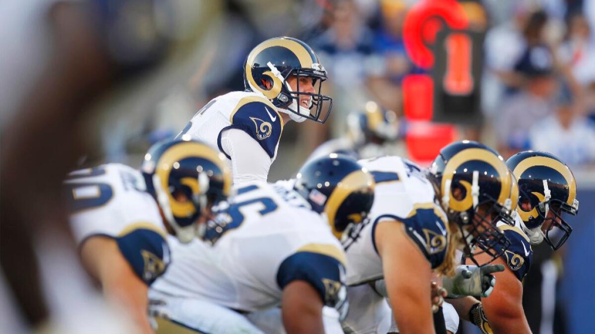 Rams rookie quarterback Jared Goff gets set to run a play during his NFL debut at the Coliseum on Aug. 13.