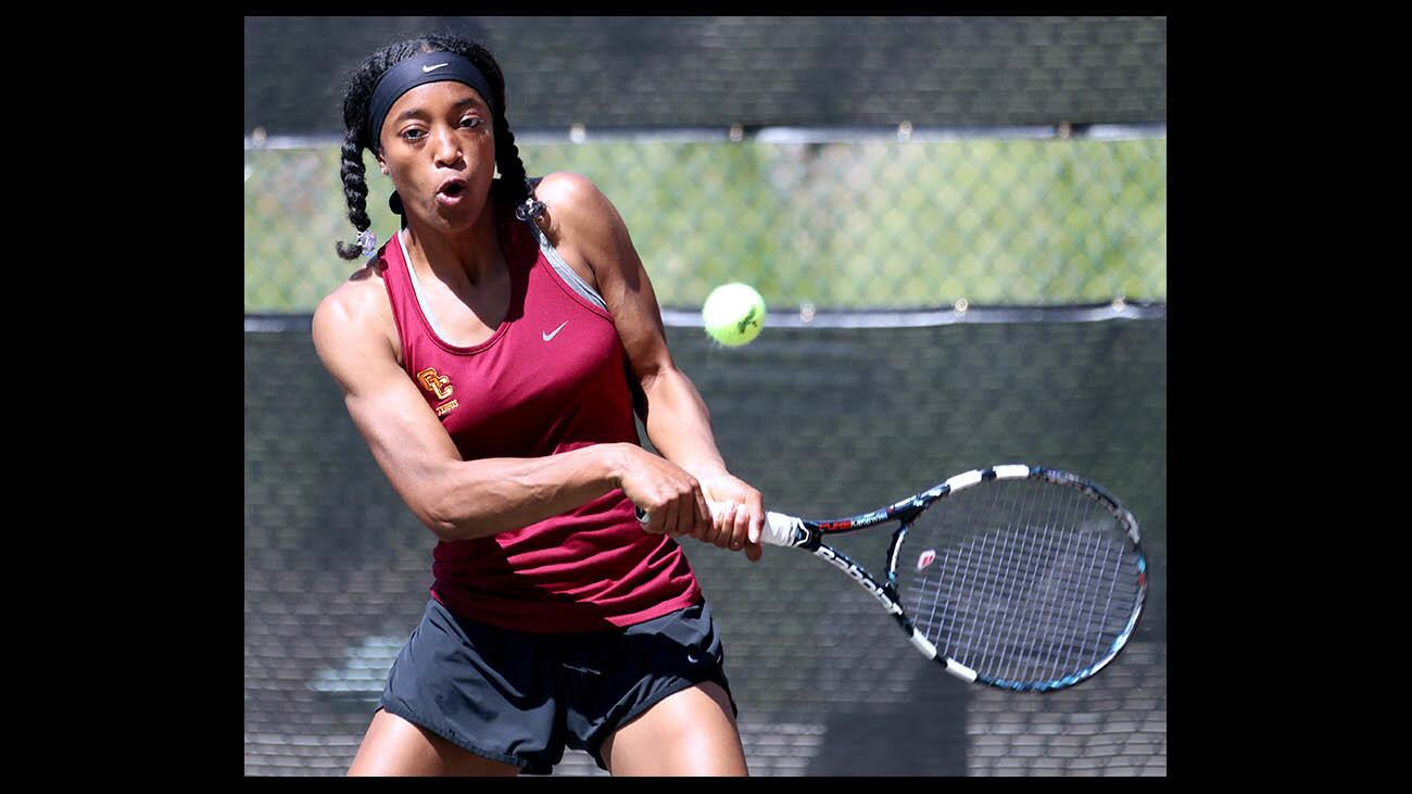 Glendale Community College women's tennis player Miah Webb returns the ball during match vs. Santa Barbara City College, at the Vaqueros home courts in Glendale, on Thursday, March 29, 2018.