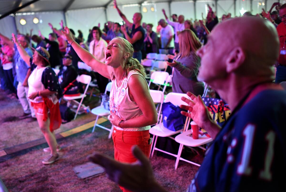 Attendees at a pro-Trump ReAwaken Tour rally in Las Vegas pray and sing on Aug. 24. 