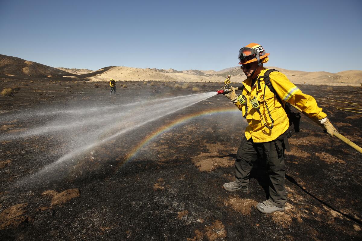 A firefighter sprays water from a hose