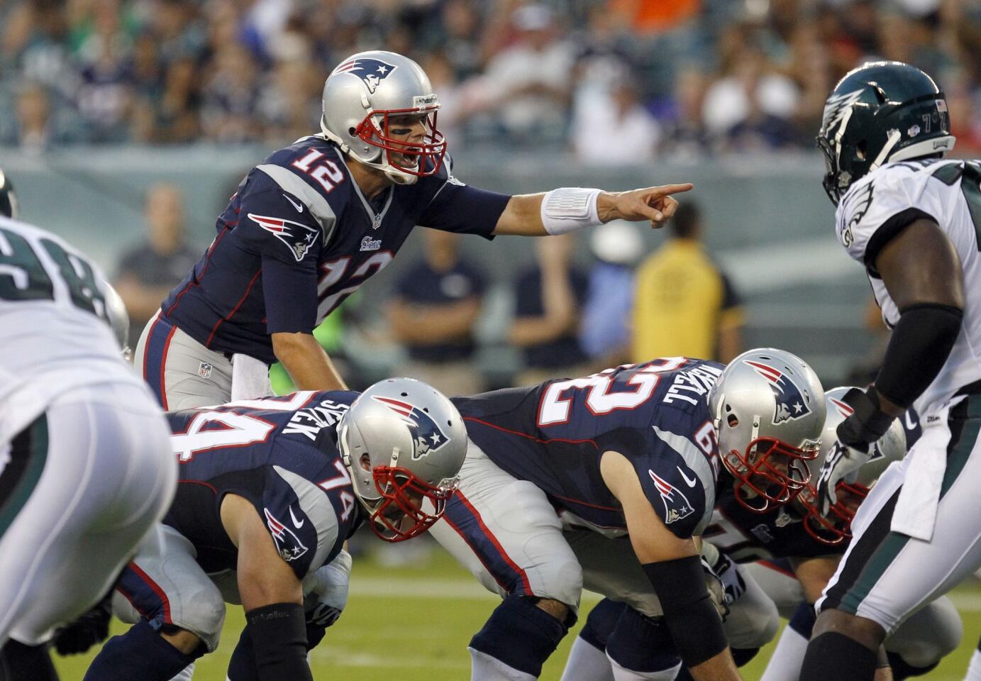 New England Patriots quarterback Tom Brady (12) sets the offense while playing against the Philadelphia Eagles during the first quarter of their NFL pre-season football game in Philadelphia, Pennsylvania, August 9, 2013.