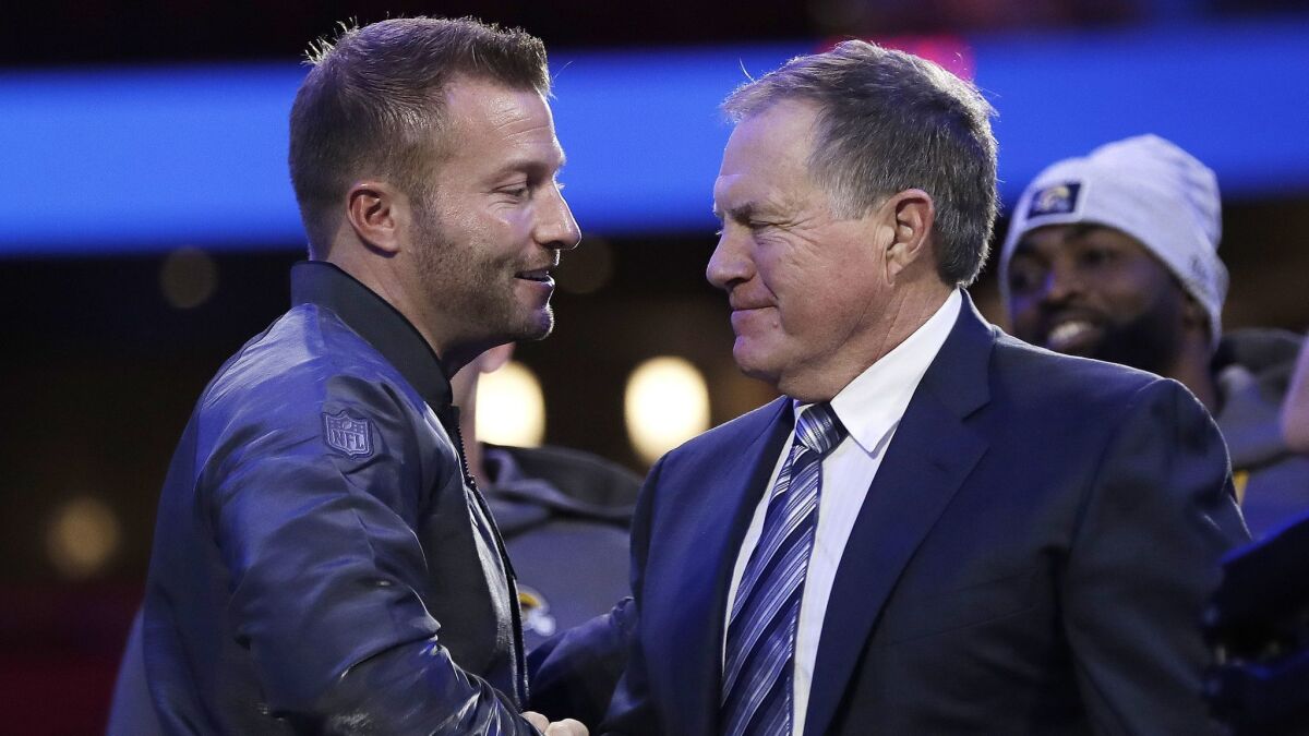 Rams coach Sean McVay, left, shakes hands with Patriots coach Bill Belichick during Super Bowl Opening Night.