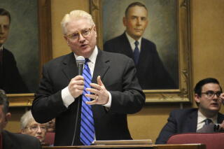 Then-Arizona Republican state Sen. Bob Worsley speaking into a hand-held microphone