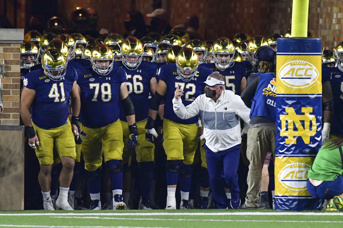 Notre Dame coach Brian Kelly leads the team out of the tunnel for an NCAA college football game against Clemson on Saturday, Nov. 7, 2020, in South Bend, Ind. (Matt Cashore/Pool Photo via AP)