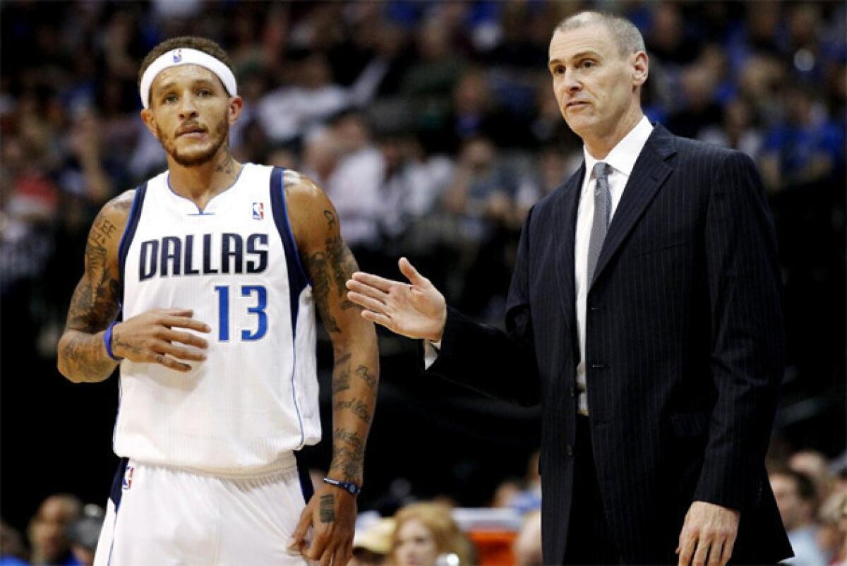 Delonte West, seen here with Dallas Mavericks coach Rick Carlisle, was waived by Dallas Mavericks to make room for Eddy Curry.