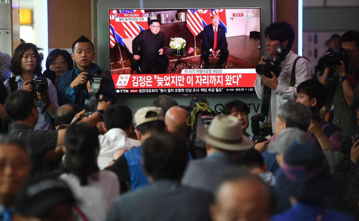 A crowd of South Koreans watch live footage of the summit between President Trump and North Korean leader Kim Jong Un in Singapore at a railway station in Seoul.
