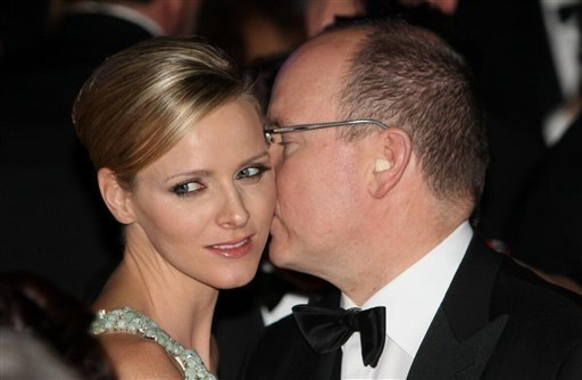 FILE - In this Saturday, March 27, 2010 file photo Prince Albert of Monaco dances with his friend Charlene Wittstock during the "Rose Ball" in Monaco. The royal palace says Prince Albert of Monaco is engaged to South African former swimmer Charlene Wittstock. The principality says in a statement that the engagement was announced between the 52-year-old prince and 32-year-old Wittstock, Wednesday June 23, 2010. (AP Photo/Lionel Cironneau, Pool)