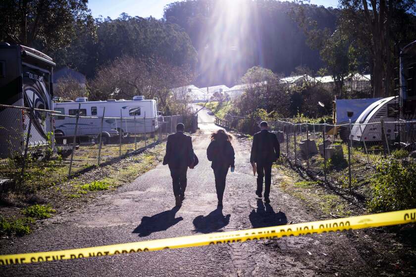 FBI officials walk towards the crime scene at Mountain Mushroom Farm, Tuesday, Jan. 24, 2023, after a gunman killed several people at two agricultural businesses in Half Moon Bay, Calif. Officers arrested a suspect in Monday's shootings, 67-year-old Chunli Zhao, after they found him in his car in the parking lot of a sheriff's substation, San Mateo County Sheriff Christina Corpus said. (AP Photo/Aaron Kehoe)