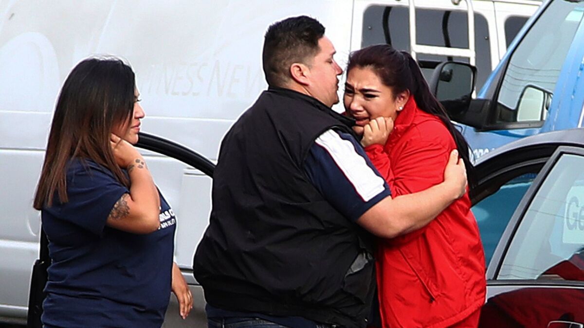 Fernando Juarez, 36, of Napa, embraces his sister Vanessa Flores, 22, at the Veterans Home of California in Yountville. Flores, a caregiver at the facility, exchanged texts with family while sheltering in place.