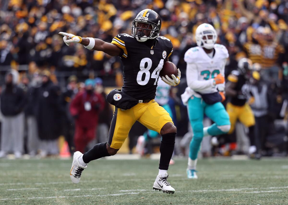 Steelers receiver Antonio Brown (84) runs down field for a touchdown after catching a pass from Ben Roethlisberger (not pictured) during the first quarter of a playoff game against the Miami Dolphins on Jan. 8.