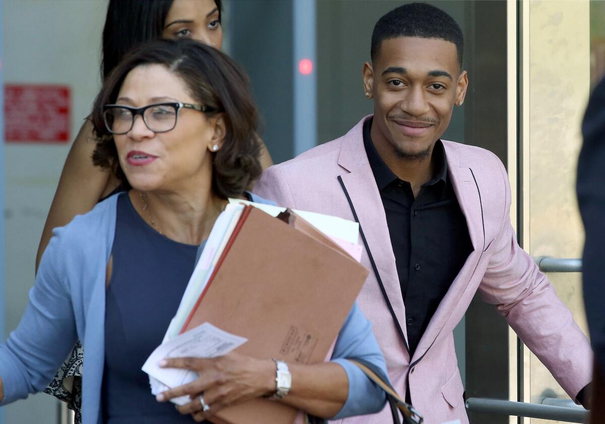 Attorney Shawn Holley, left, leaves Los Angeles County Superior Court with her client, rapper Lil Za, after his arraignment.