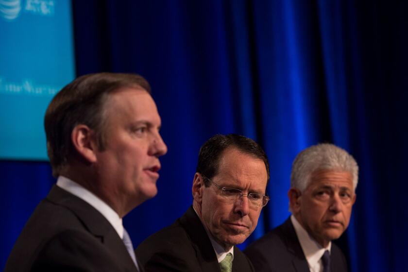 NEW YORK, NY - NOVEMBER 20: AT&T Chairman and CEO Randall Stephenson (C) and retained Counsel from O'melveny & Myers listen to AT&T Senior Executive Vice President David R McAtee II at a news conference in Time Warner headquarters addressing the latest developments in the AT&T and Time Warner merger on November 20, 2017 in New York City. The U.S. Justice Department filed sued today to block AT&T's proposed $85.4 billion takover of of Time. (Photo by Amir Levy/Getty Images) ** OUTS - ELSENT, FPG, CM - OUTS * NM, PH, VA if sourced by CT, LA or MoD **