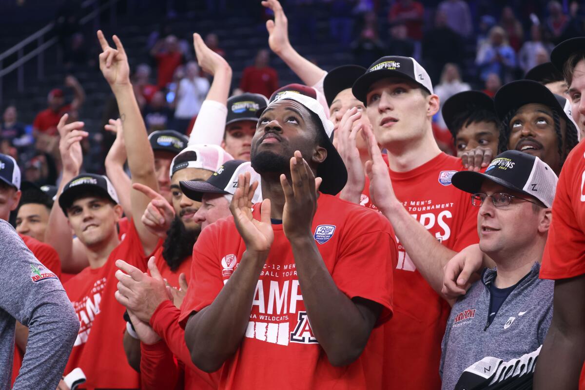 Arizona guard Courtney Ramey, center, celebrates with teammates after their win over UCLA in the Pac-12 tournament final.