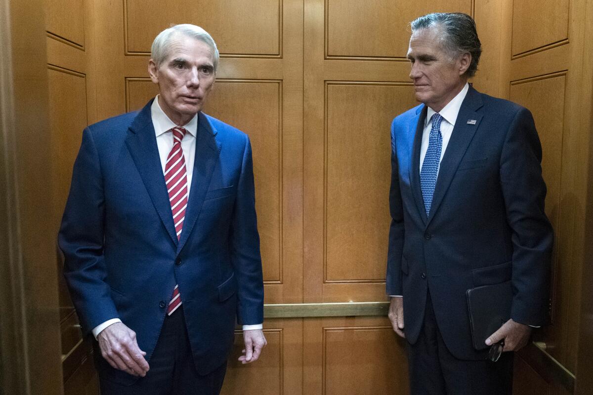 Rob Portman and Mitt Romney in an elevator.