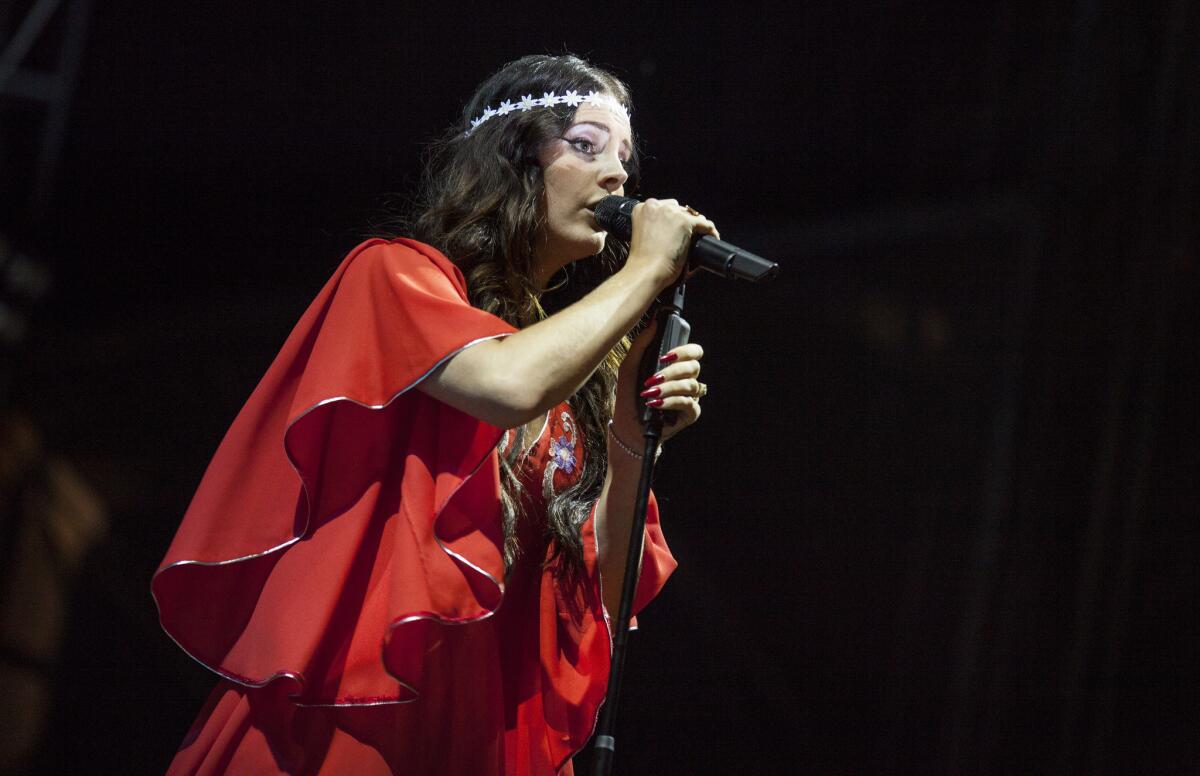 Lana Del Rey performs during the 2013 Lollapalooza festival at Chicago's Grant Park. In 2017, the now-34-year-old singer and songwriter recorded the song "Coachella — Woodstock in My Mind." 
