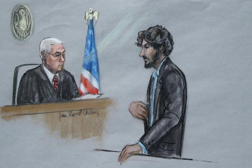 In this courtroom sketch, Boston Marathon bomber Dzhokhar Tsarnaev, right, stands before U.S. District Judge George O'Toole Jr. as he addresses the court during his sentencing.