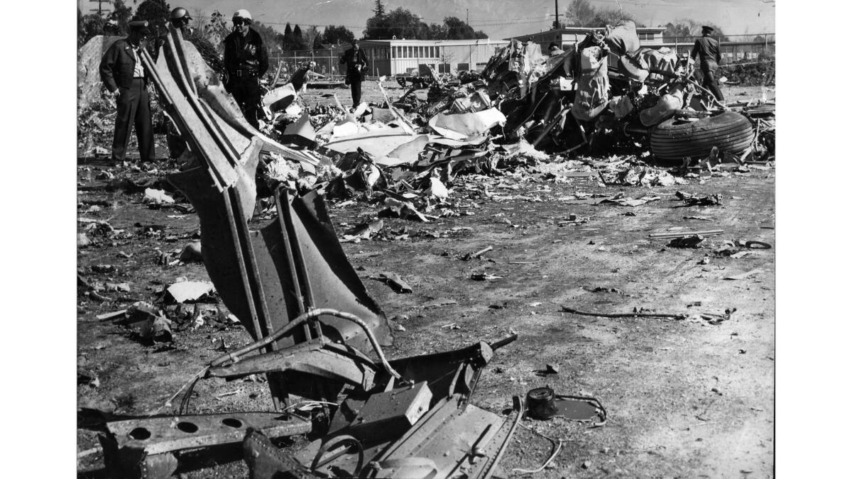 Jan. 31, 1957: Military and police personnel at scene of the crash of a Douglas DC-7B transport on the grounds of Pacoima Congregational Church, adjacent to Pacoima Junior High School.