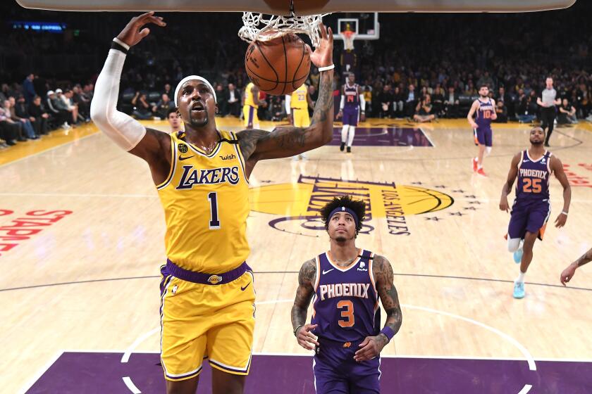 LOS ANGELES, CALIFORNIA FEBUARY 10, 2020-Lakers Kentavious Caldwell-Pope dunks over Suns Kelly Oubre Jr. at the Staples Center Monday. (Wally Skalij/Los Angeles Times)