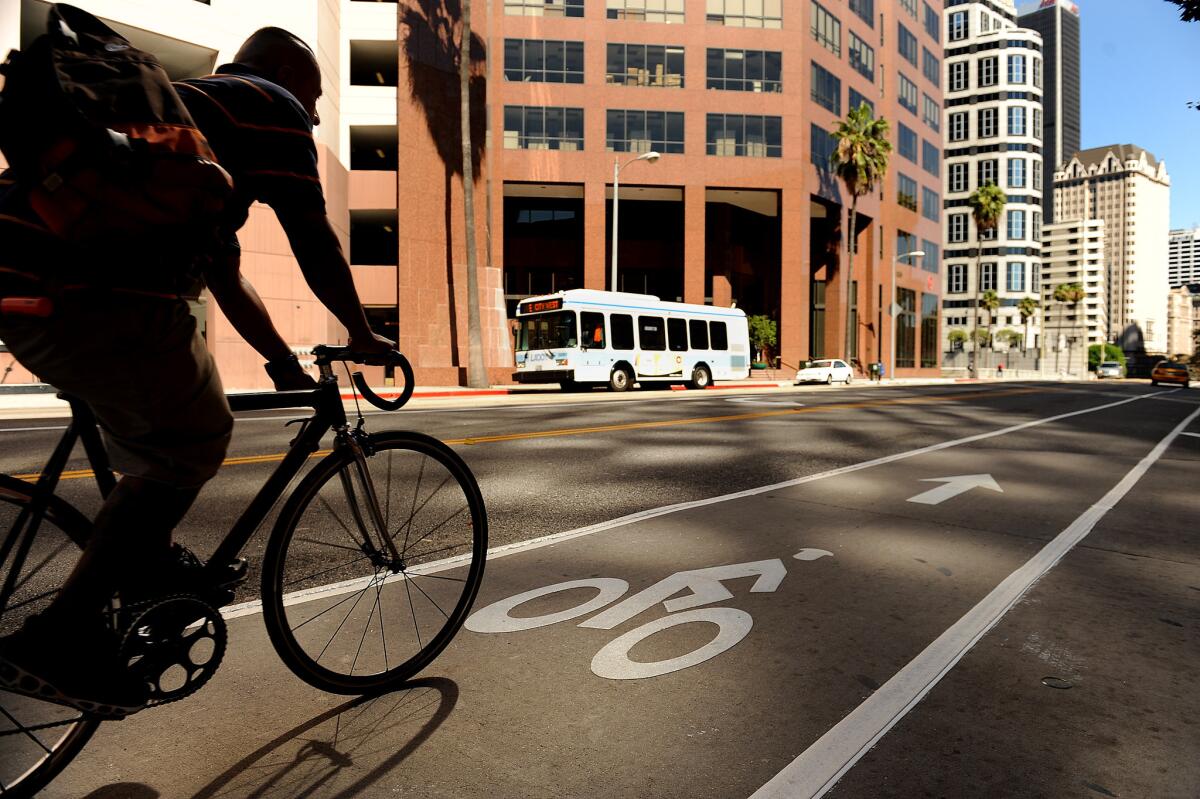 A bike lane on 7th Street is one of several such pedal-focused commuter lanes introduced in downtown Los Angeles. Efforts are underway to put more people on bikes and public transit.