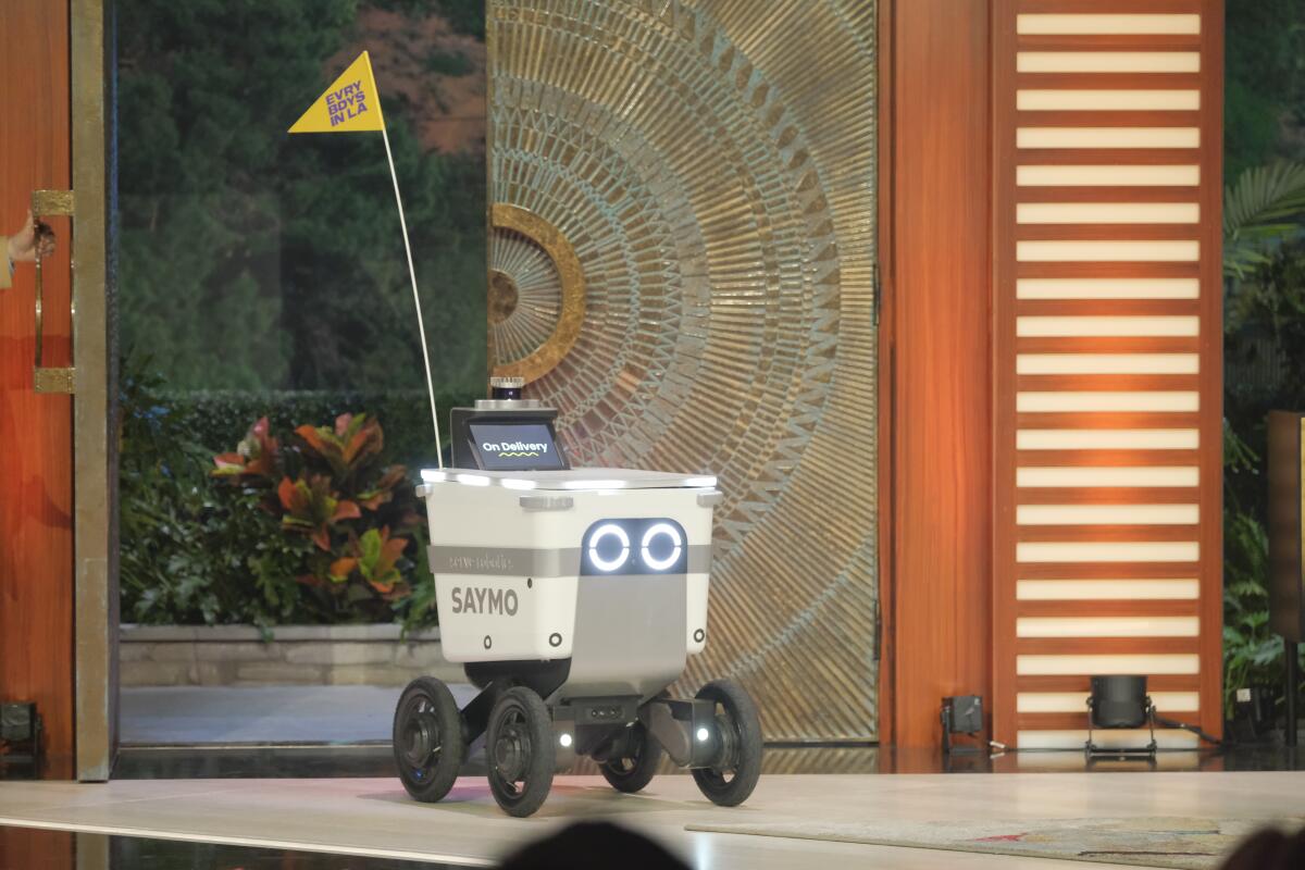 A delivery robot rolling onstage.