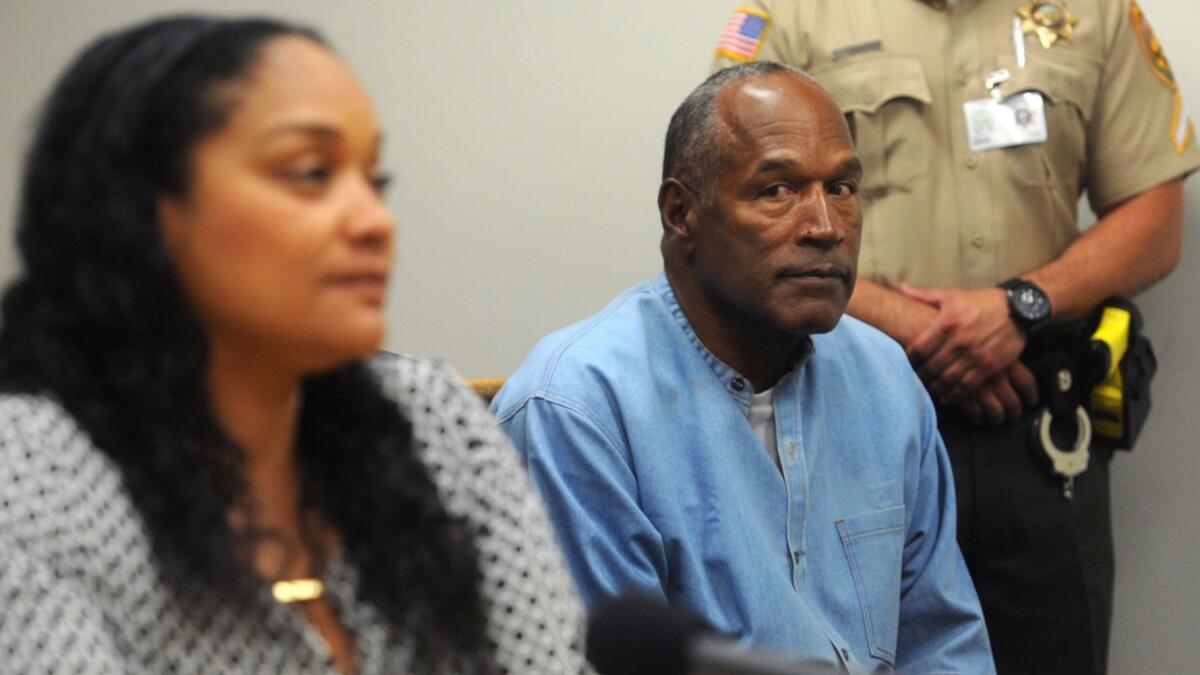 O.J. Simpson listens as his daughter Arnelle Simpson testifies during his parole hearing.
