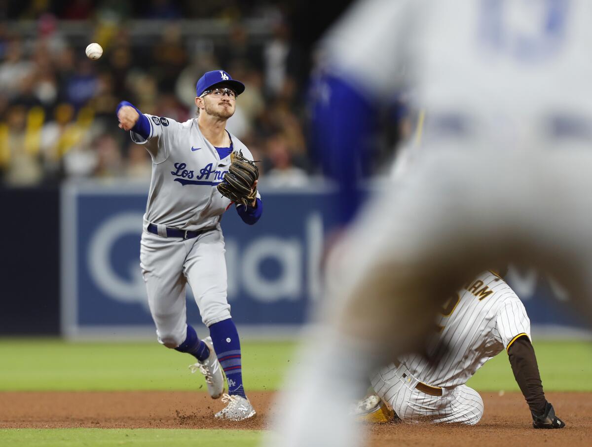 Dodgers second baseman Zach McKinstry forces out Trent Grisham at second base.