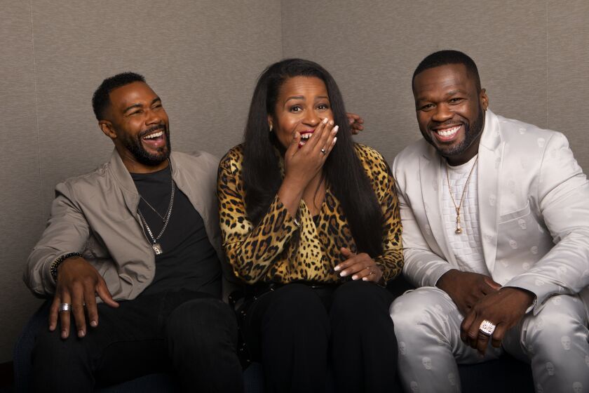 BEVERLY HILLS, CA JULY 26, 2019: Portrait of Omari Hardwick, left, Courtney A. Kemp, middle, and Curtis Jackson, better known as rapper 50 Cent, at the Beverly Hilton Hotel in Beverly Hills, CA July 26, 2019. Starz' "Power", which centers on an African American drug dealer and night club owner and his shaky attempts to escape his criminal past, is winding up on Starz after five season. . Omari Hardwick stars as James "Ghost" St. Patrick in the series, which was created by Courtney A. Kemp. 50 Cent, is an executive producer and plays a recurring role as a ruthless thug (his character was killed last season). (Francine Orr/ Los Angeles Times)