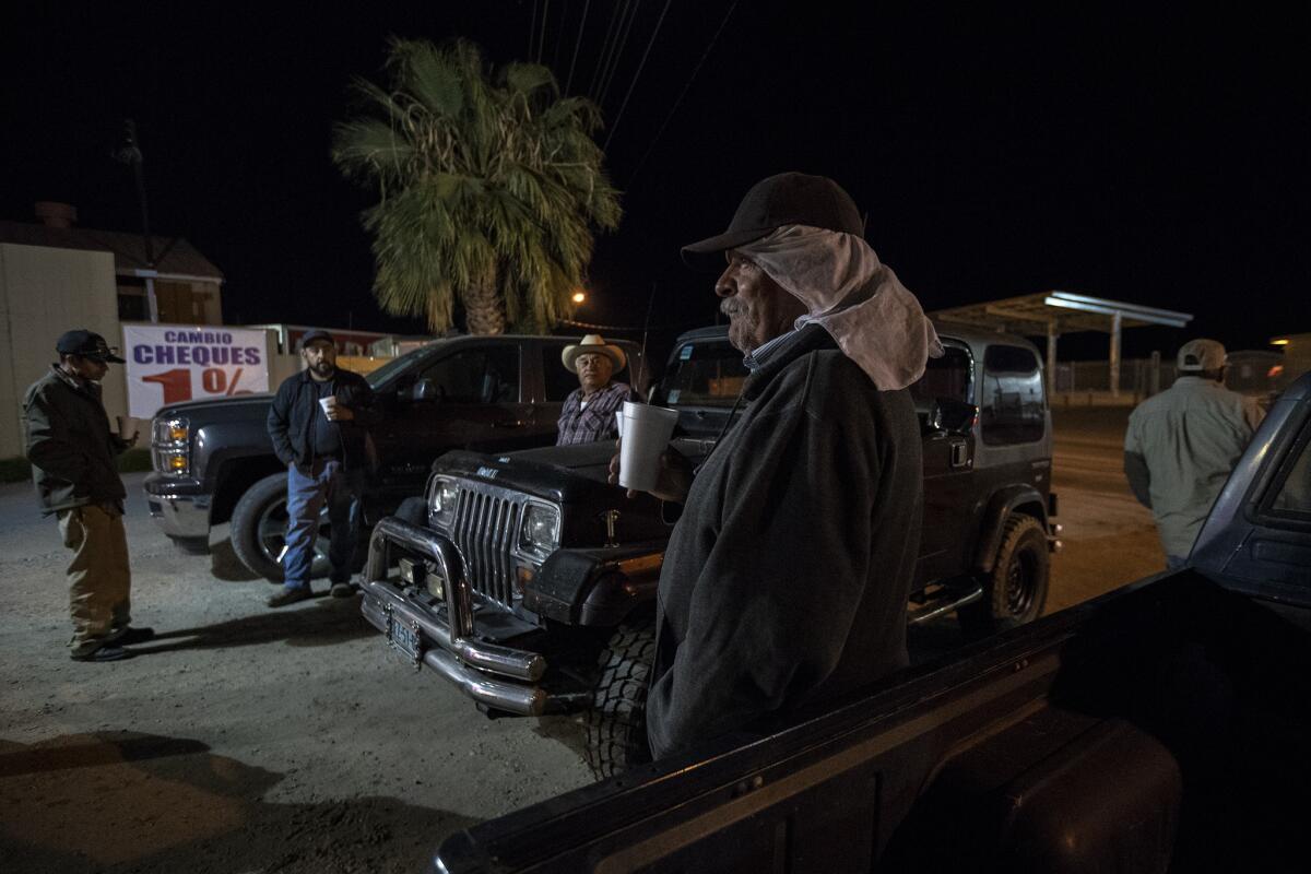 Farmworkers gather for early-morning coffee before heading off to work.