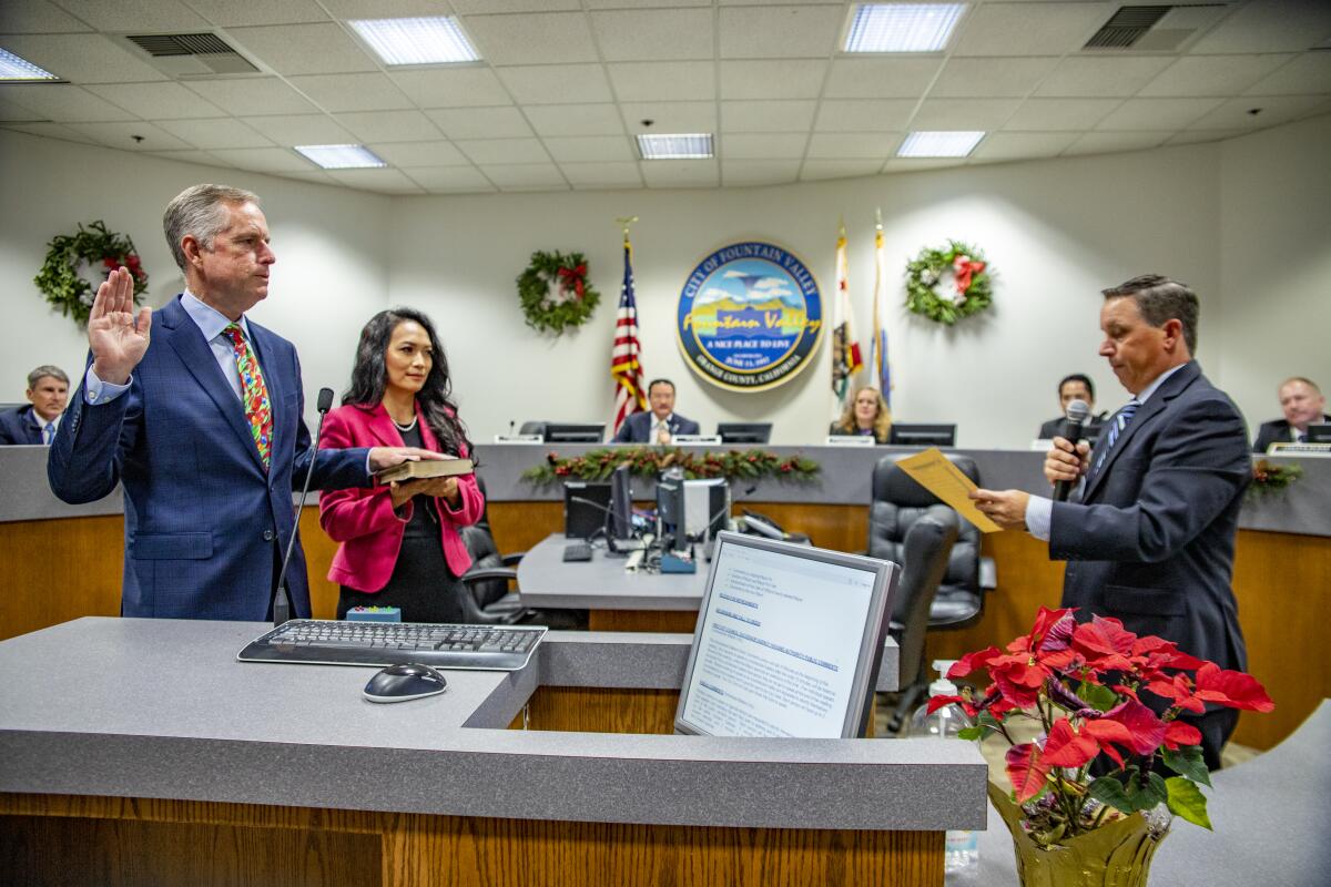 Patrick Harper is sworn in as Fountain Valley's new mayor by City Clerk Rick Miller.
