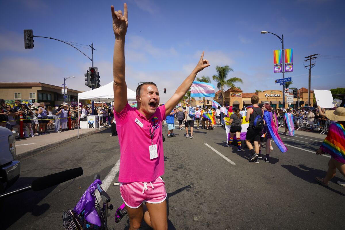 Fernando López, Executive Director of San Diego Pride cheered on parade participants.