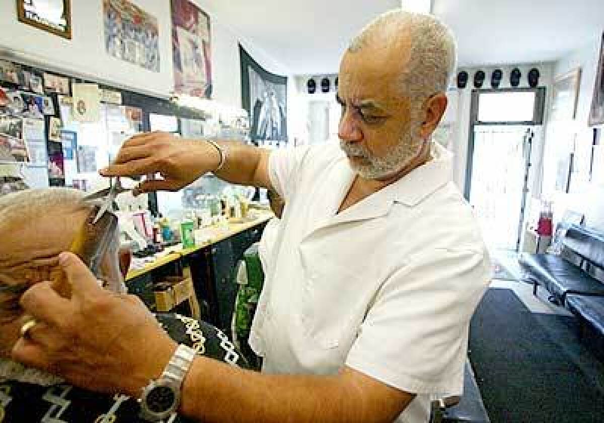 Lawrence Tolliver at his West Florence Avenue barbershop.