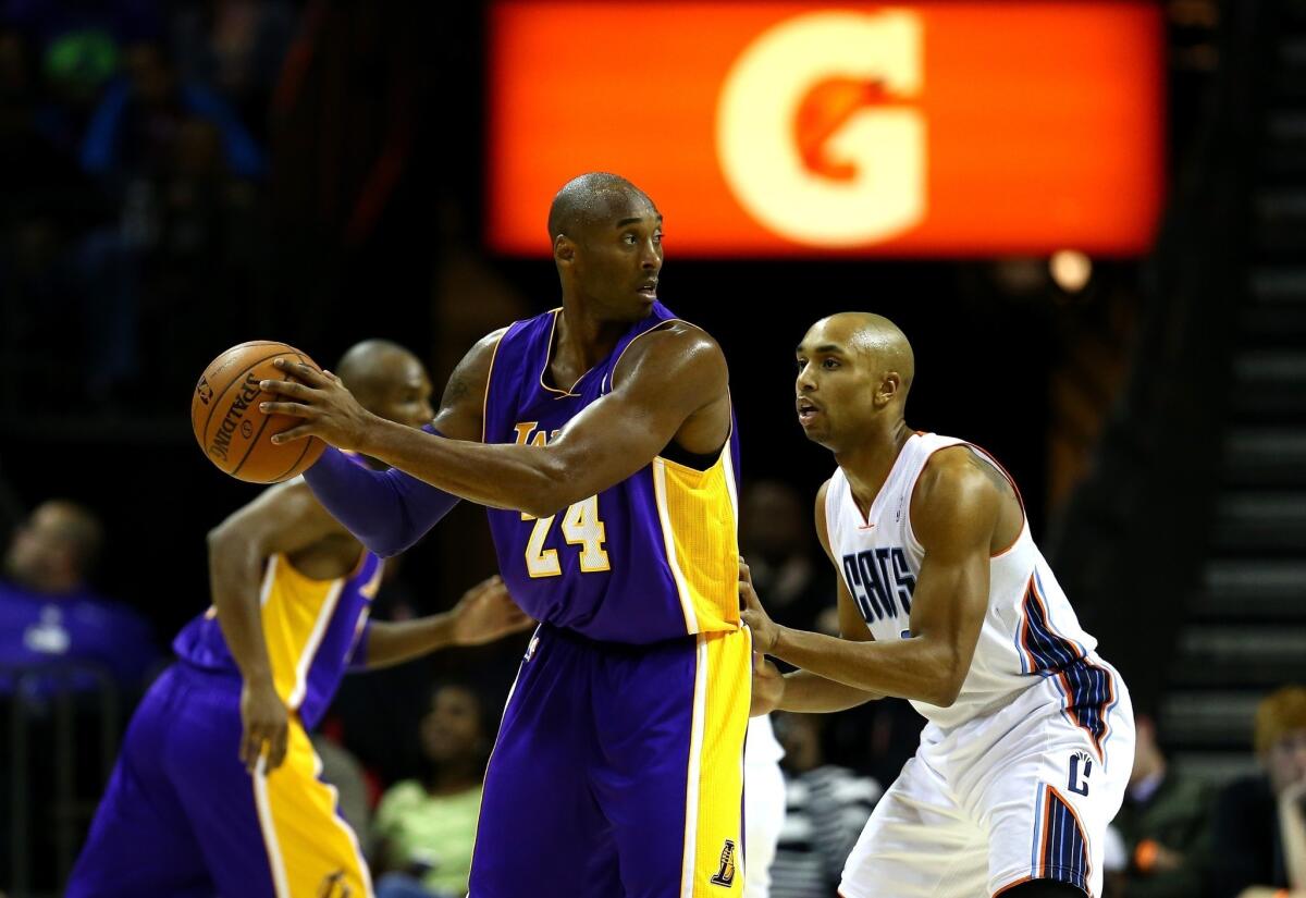 Kobe Bryant, guarded by Charlotte's Gerald Henderson, scored a team-high 21 points in the Lakers' 88-85 victory Saturday at Time Warner Cable Arena.
